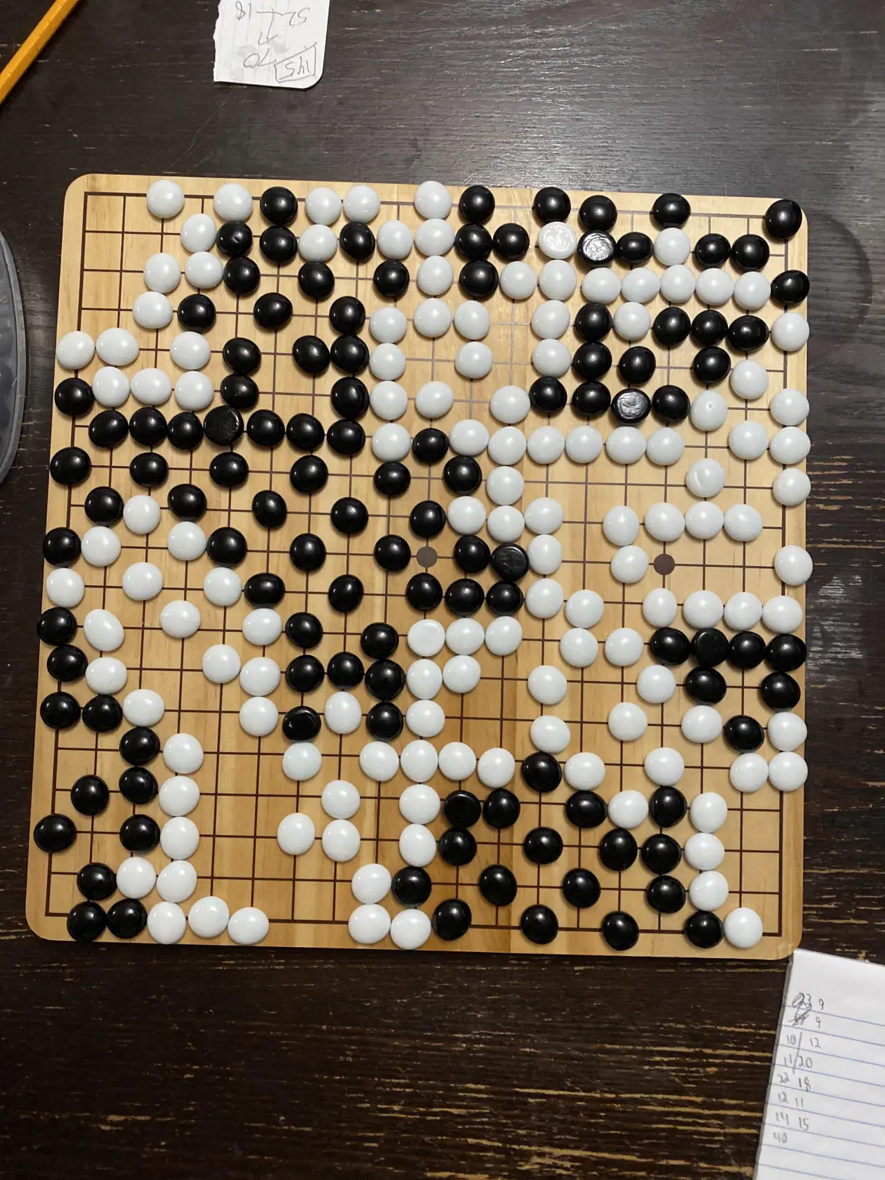 Go board game with black and white stones